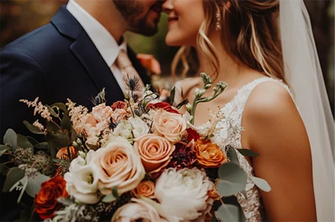 Newly married couple holding flowers